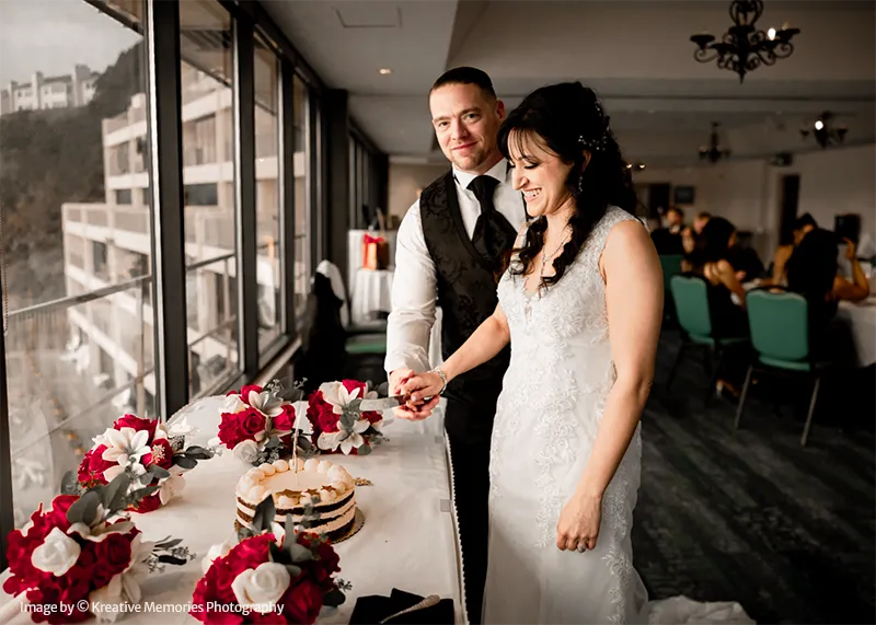 Inn at Spanish Head Wedding Bride and Groom Photoshoot Cutting Cake in El Toro Event Room