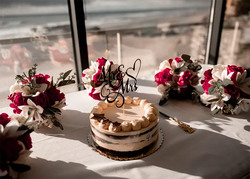 Inn at Spanish Head Wedding Cake in Event Venue Ocean Backdrop