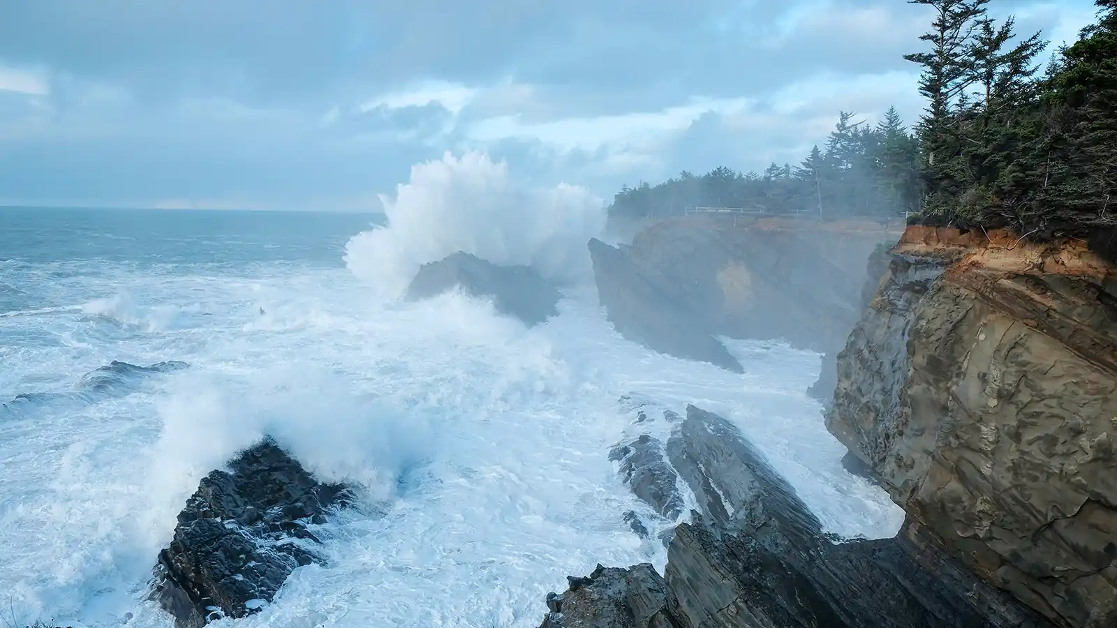 king tide waves crashing on rocks on the Oregon Coast.